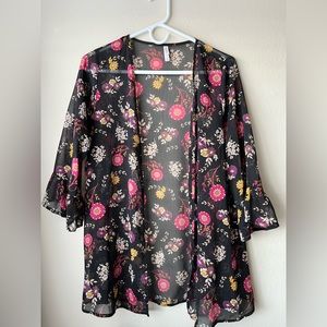 Black cover up with pink, white & yellow flowers all over.